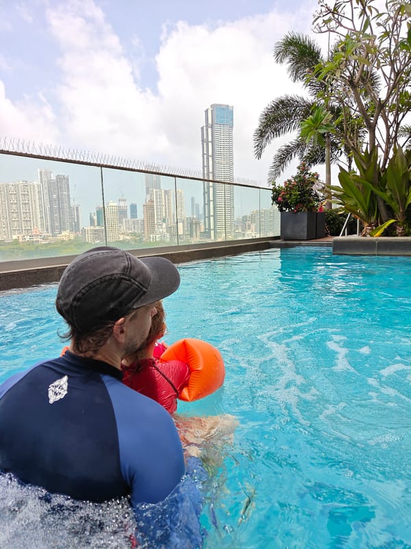 Father and child enjoy swimming session in Mumbai rooftop pool