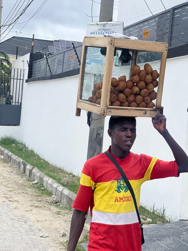 Street vendor sells fried dough balls in Igboefon, Nigeria