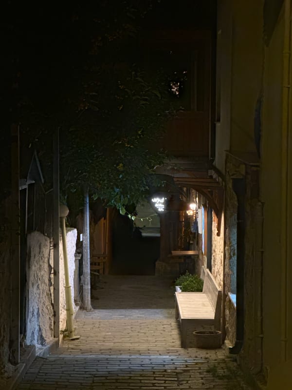Nighttime scene captured in narrow Kaş alleyway