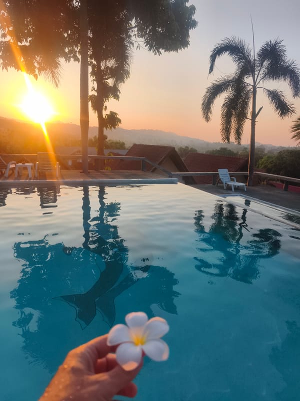 Person reaches toward infinity pool in Koh Samui Thailand