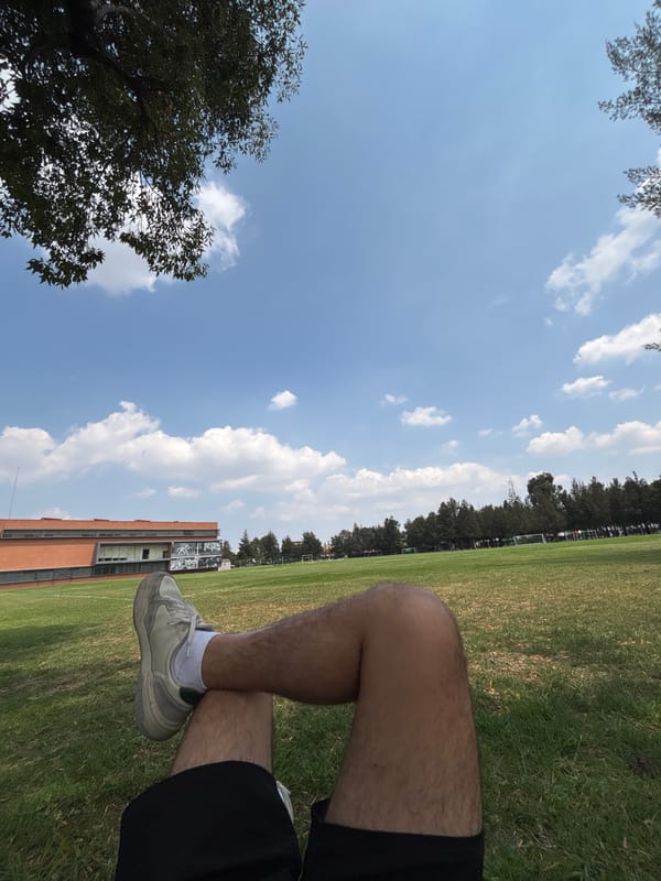 Person sits on grass field in San Andrés Cholula