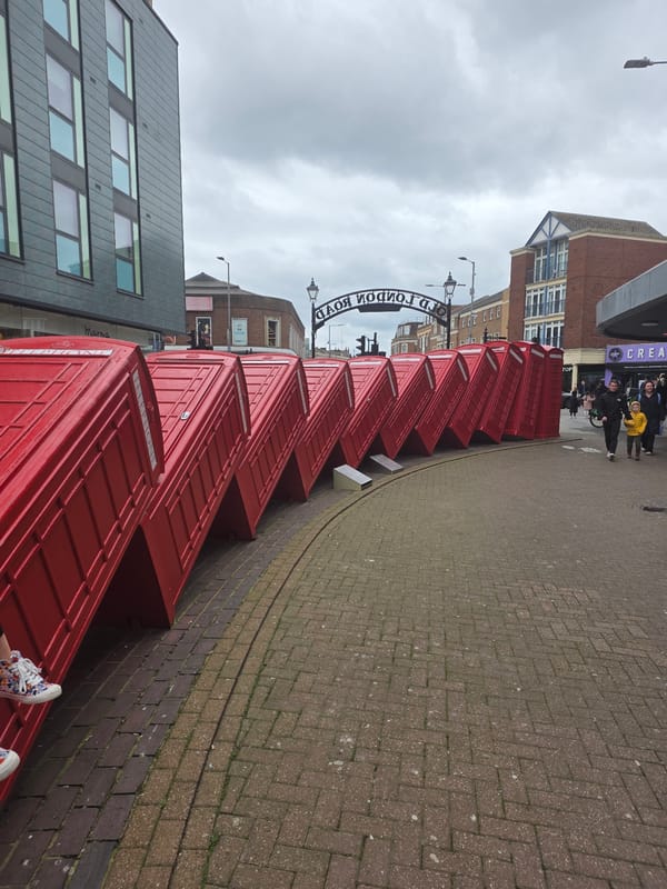 Red phone booths line Old London Road street