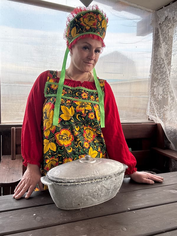 Woman in traditional Russian dress tends garden in Chaikovsky
