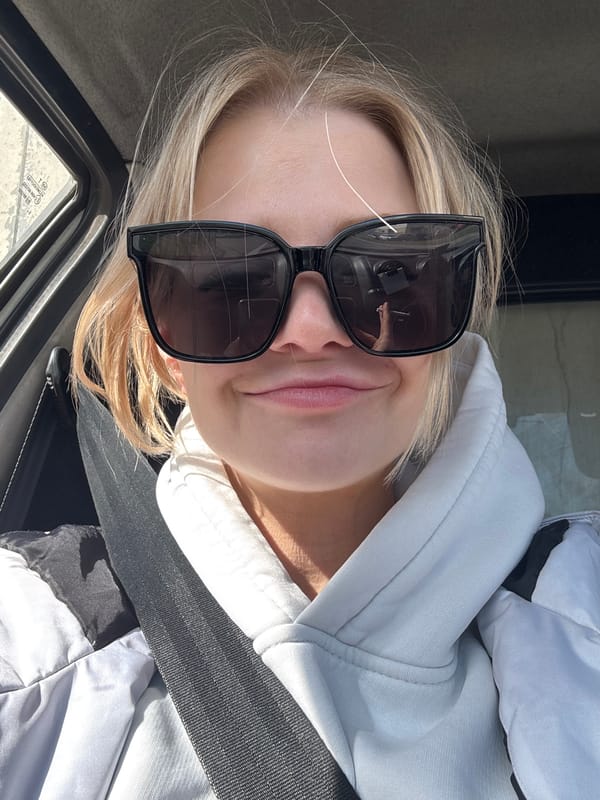 Person in sunglasses photographed in vehicle, Saint Petersburg