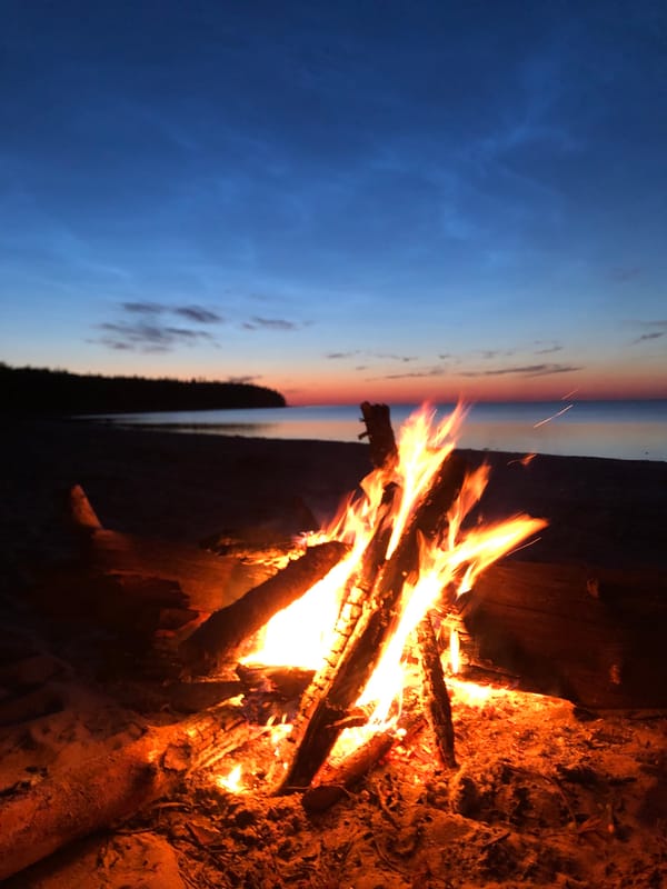 Beach bonfire at dusk on a Russian lakeshore