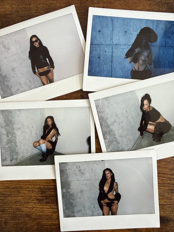 Polaroid portraits scattered on wooden surface in London