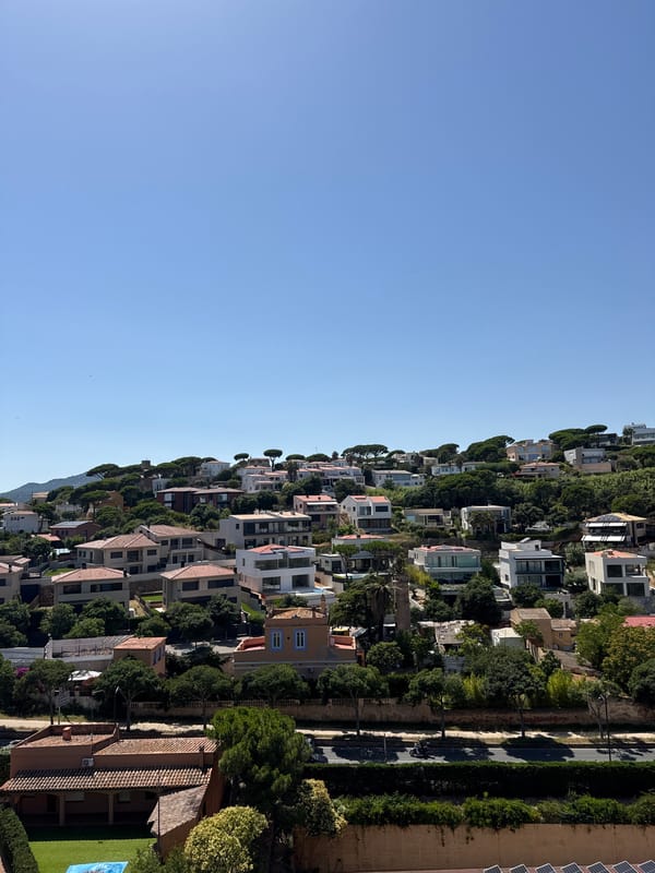 Sunny hillside neighborhood overlooking the Costa Brava coast