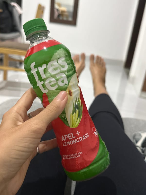 Person enjoys tea while watching TV in Kuta Selatan
