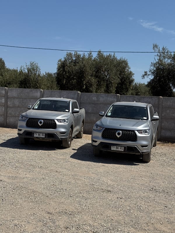 Two matching pickup trucks parked in Arica, Chile