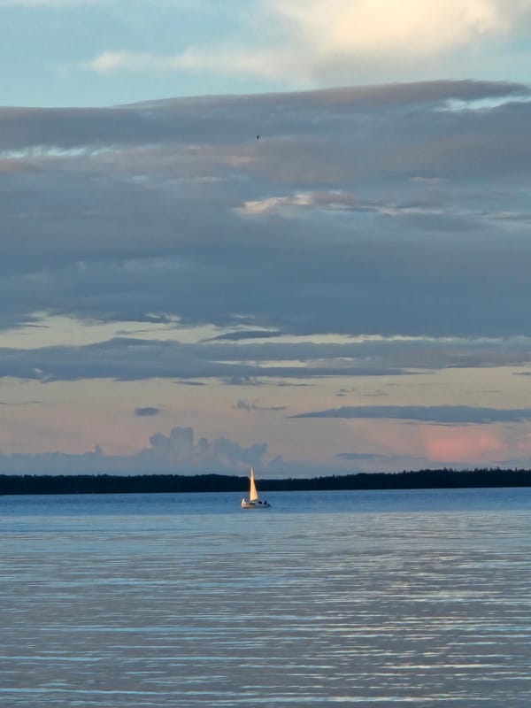 Calm waters and blue-domed churches at golden hour