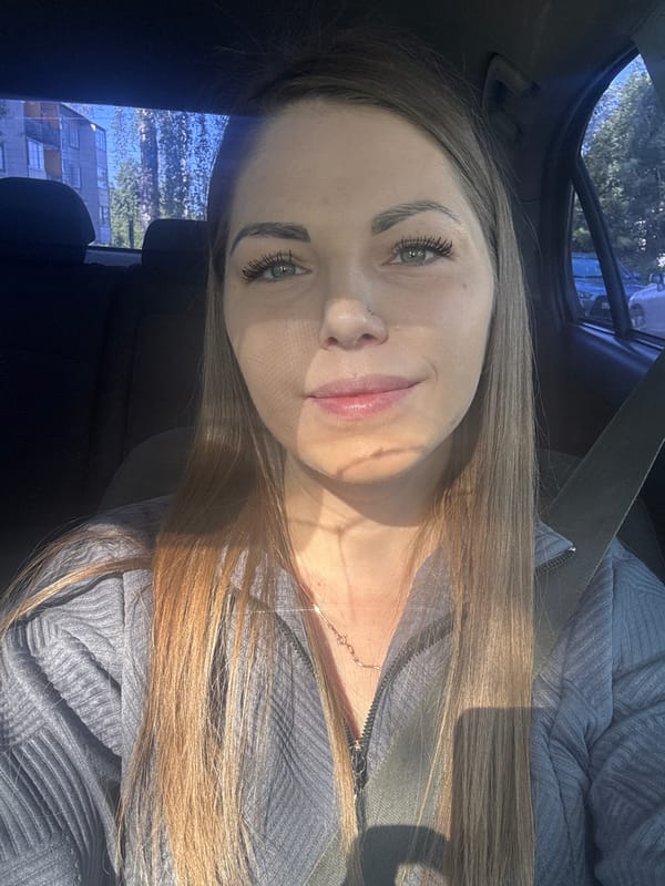 Woman photographed seated in car in Razdolye, Russia