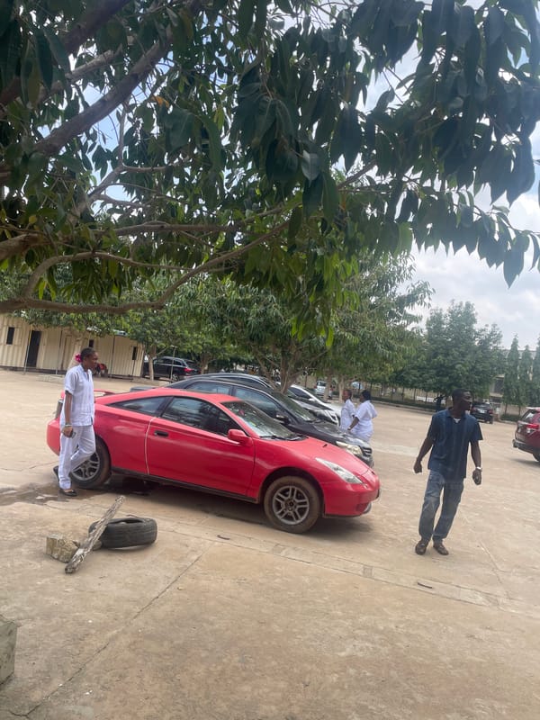 Vehicles parked in an open compound, Abuja