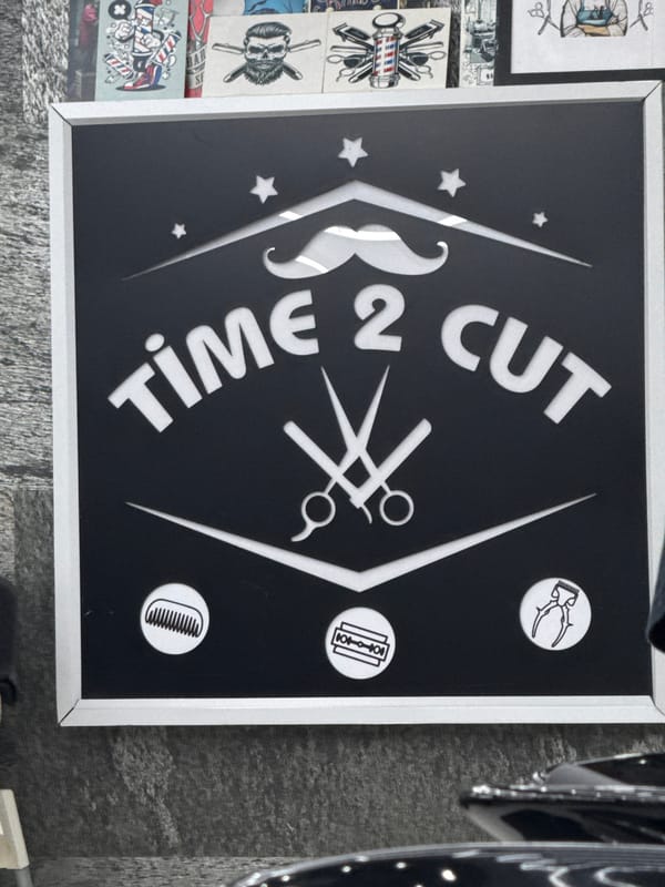Barbershop sign displays "TIME 2 CUT" message