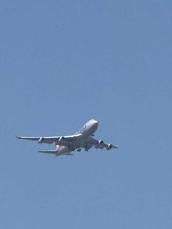 White jet on descent through clear skies over Luxembourg