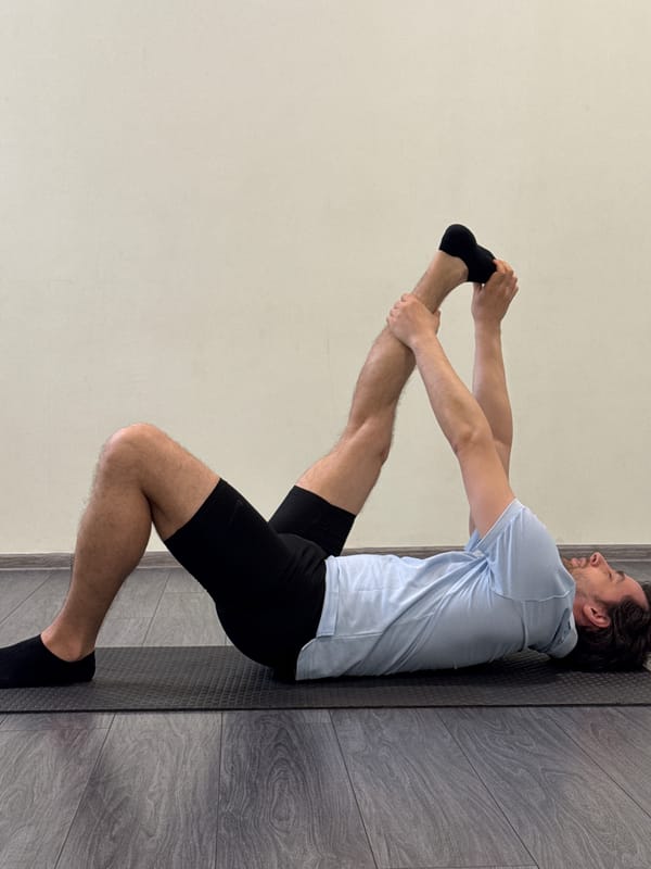 Man performs morning stretching routine against wall