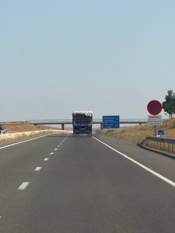 Truck travels highway through rural Morocco farmland