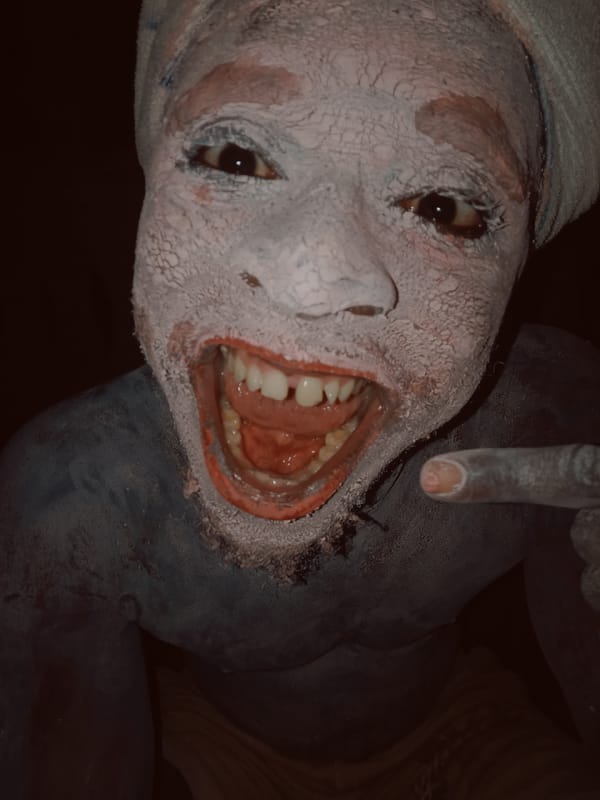 Person in traditional white clay paint photographed in Onitsha