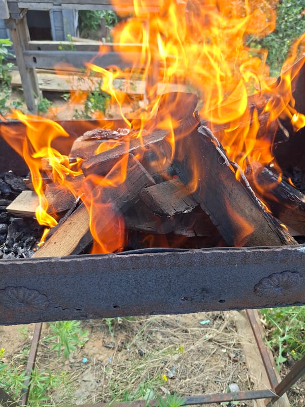 Wood fire burning in an outdoor metal grill