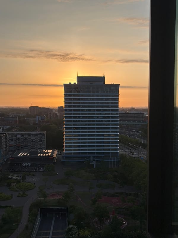 Sunrise captured over Rijswijk skyline from elevated window view