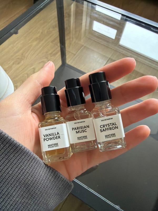 Person displays three glass perfume bottles in London
