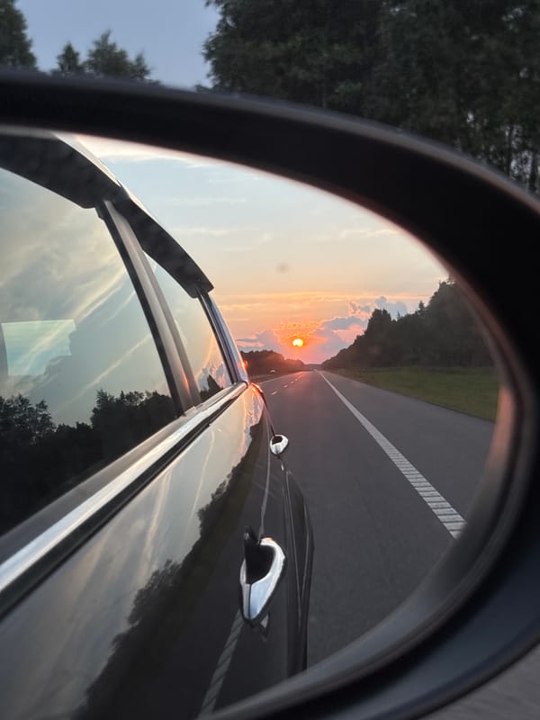 Sunset reflected in a rearview mirror on a Belarus highway