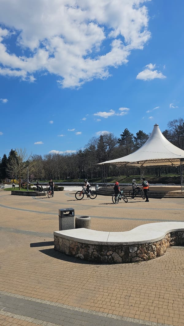 Cyclists ride through plaza in Dobrich, Bulgaria