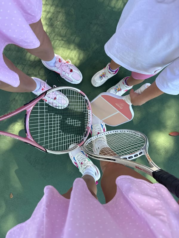 Four people gather in circle on Naples sports court