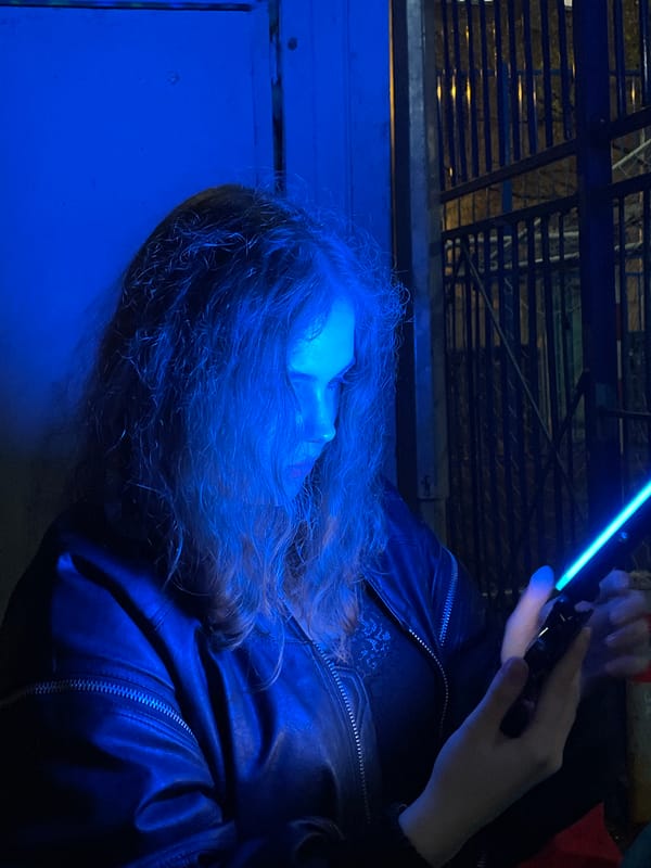 Person tests colored light device outside Moscow building