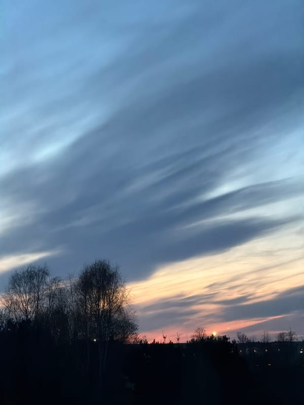 Evening sky displays colorful sunset over Dreiliņi, Latvia