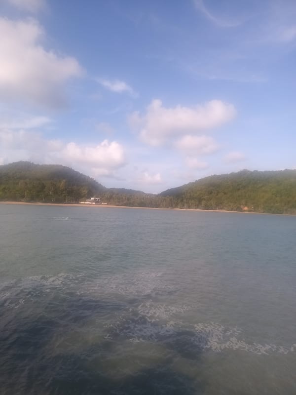 Tourist documents ferry departure from Hat Sai Ri beach Thailand