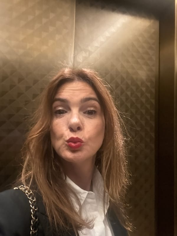 Woman takes multiple selfies on Munich's Maximilianstrasse