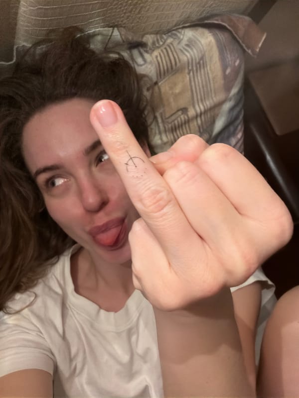 Woman photographed making gesture indoors in Khimki