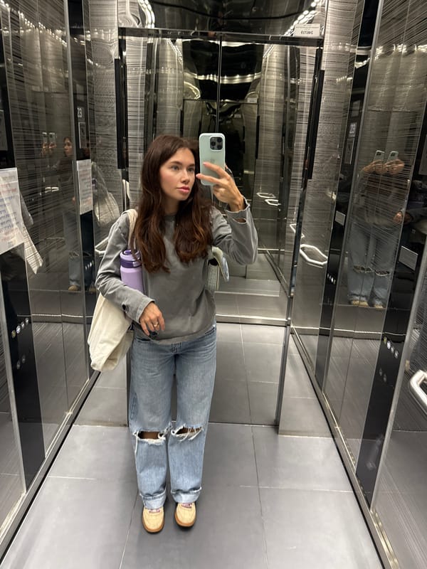 Woman takes selfie in mirrored elevator in Tel-Aviv