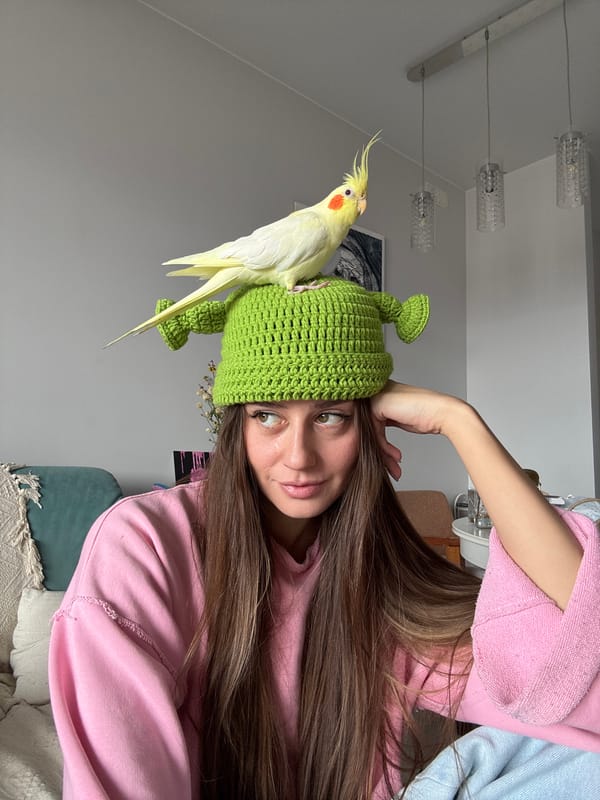 Woman poses with cockatiel in indoor portraits, Krasnoyarsk