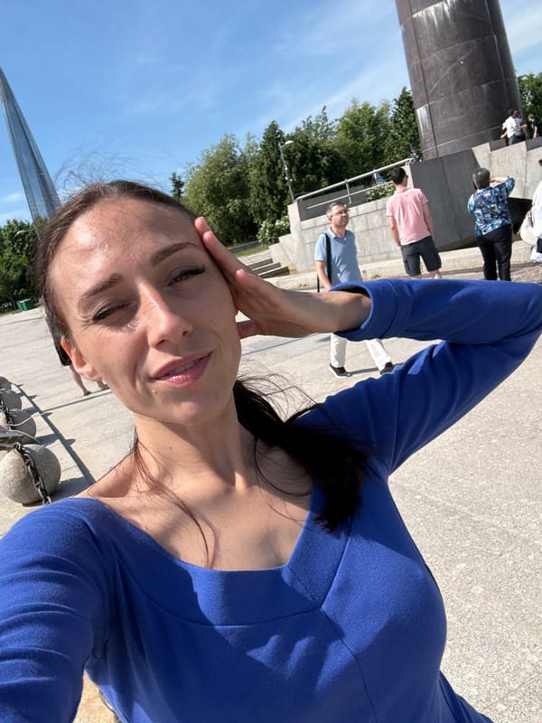 Woman takes selfies at Saint Petersburg landmarks during sunny morning