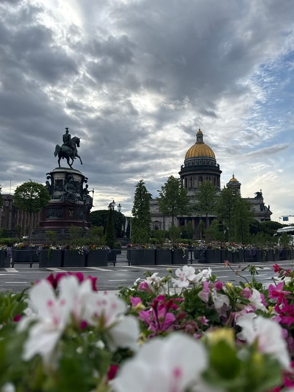St. Isaac's Cathedral and summer flowers on a cloudy afternoon