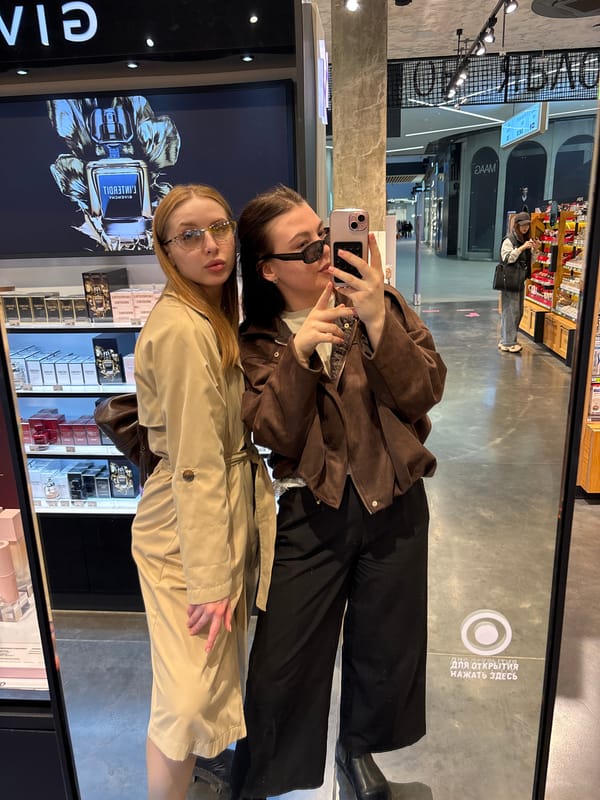 Two women take mirror selfie in Perm cosmetics store