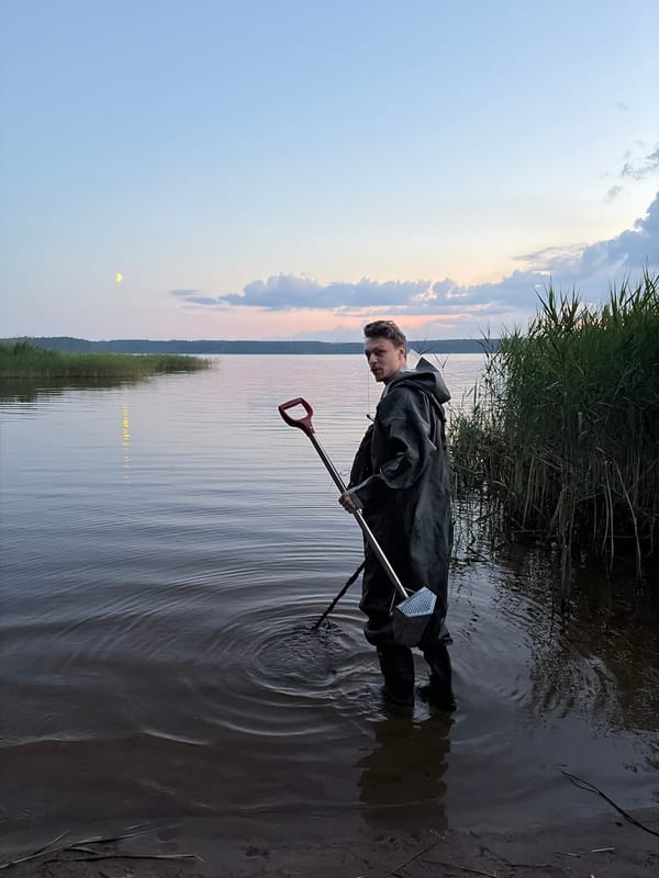 Evening metal detecting session at a lakeside camp
