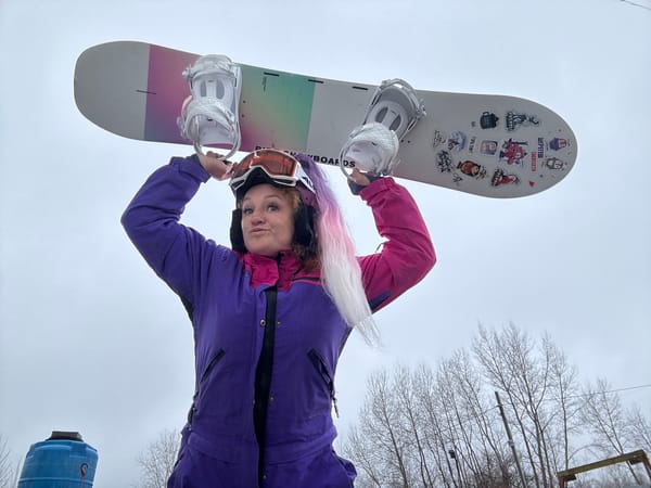 Snowboarder poses with gear in Chaikovsky, Russia