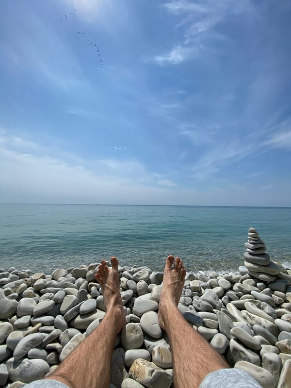 Beachgoer relaxes on pebble shore in Gelendzhik, Russia