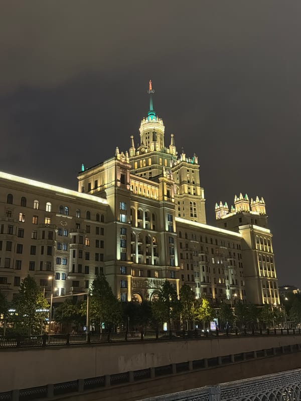 Illuminated Stalinist skyscraper observed at night in Ukraine