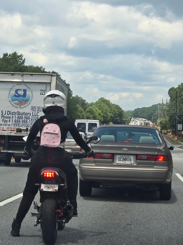 Two riders on a black motorcycle in Alpharetta, Georgia