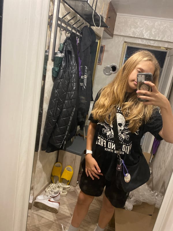 Mirror selfie in Sochi, skull graphic tee on display