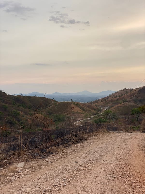 Motorcycles travel dirt mountain road near Tinaquillo, Venezuela