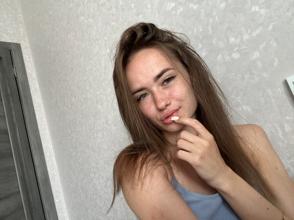 Woman Takes Series of Selfies in Light Blue Tank Top