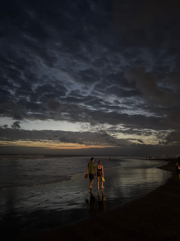 Evening beach life unfolds at Kuta during dramatic sunset