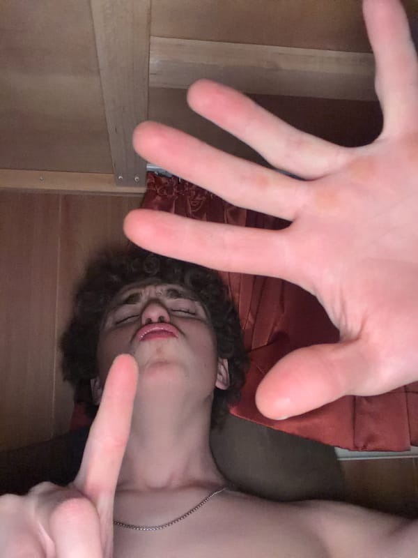 Goofing around with selfies lying down, all gestures and expressions.