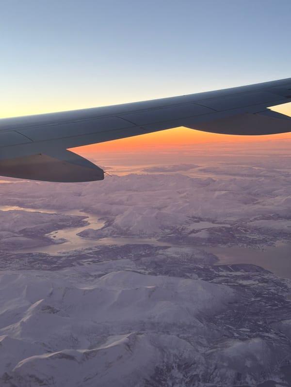 Aerial view captures sunrise over Norwegian snow-covered mountains