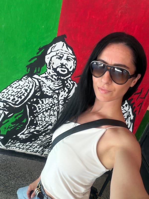 Woman photographs herself at historical mural in Pleven, Bulgaria