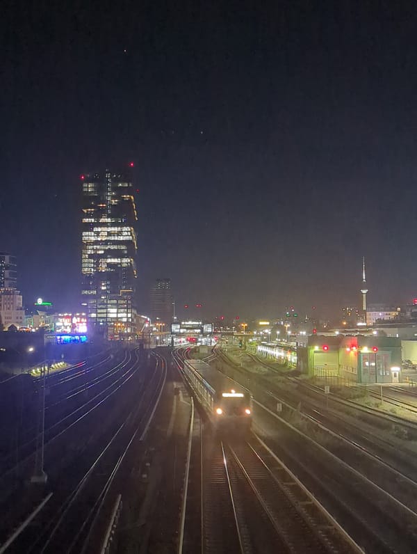 Nighttime Berlin cityscape captured from elevated train position